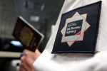 A UK Border Agency officer checking a passport